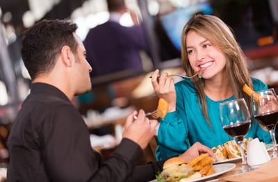 Friends eating at a restaurant  and looking happy