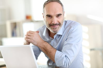 Senior businessman working on laptop computer-1