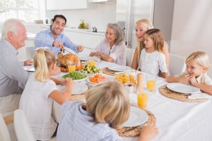 Father proposing a slice of turkey for thanksgiving