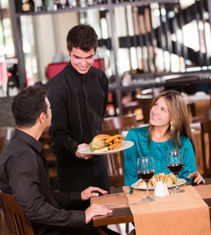 Happy couple eating at a restaurant and smiling