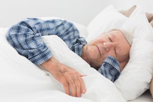 Old man sleeping on the bed