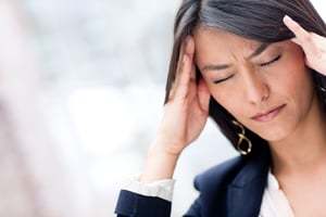 Portrait of stressed business woman with a headache