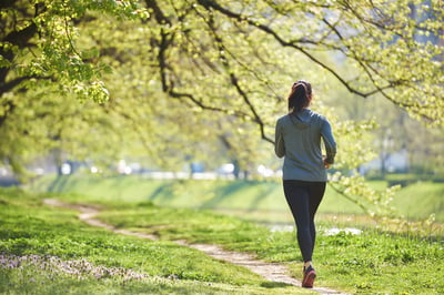 young woman jogging in city park at early morning